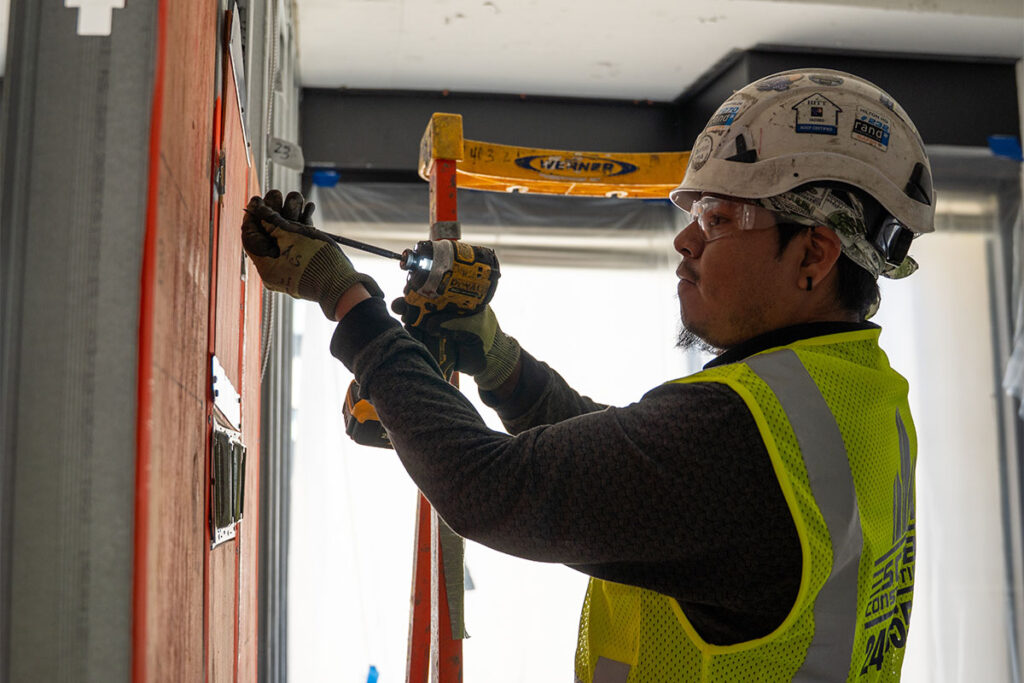 Metal framing expert drilling a nail into a metal frame in DC